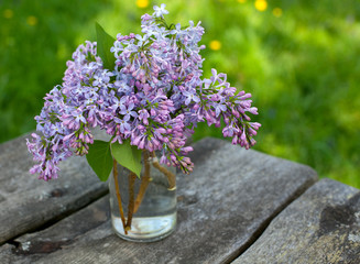 lilacs on wooden garden table