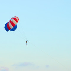 parasailing in the clear sky at summer day