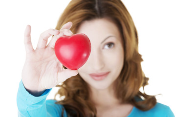 Attractive smiling woman showing red heart