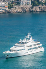 Fototapeta na wymiar Luxurious yacht sailing on clear blue water.