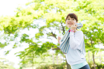 Fototapeta premium Beautiful asian woman after sport workout in the park