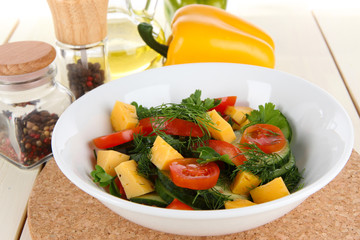 Light salad in plate on wooden table