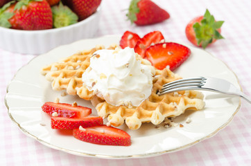 Belgian waffles with fresh strawberries, whipped cream