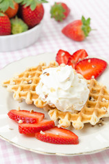 Belgian waffles with fresh strawberries and whipped cream