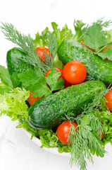bowl with fresh vegetables and herbs for salad closeup