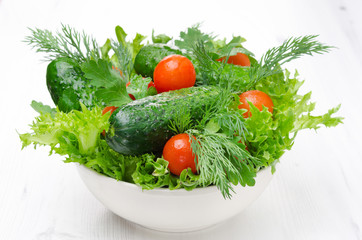 bowl with fresh vegetables and herbs for salad