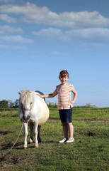 happy little girl and pony horse