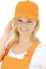 Freundliche junge Bauarbeiterin mit Schutzbrille
