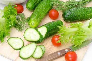 ingredients for salad - fresh cucumbers, tomatoes, herbs