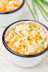 salad of pickled cabbage with carrots and green onions close-up