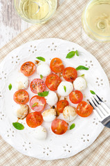salad with mini mozzarella, cherry tomatoes, basil, top view
