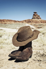 Boots and hat in front of Mexican Hat