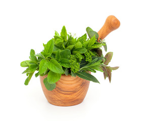 fresh herbs in a wooden mortar