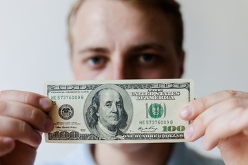 Man holding American dollars in  hands