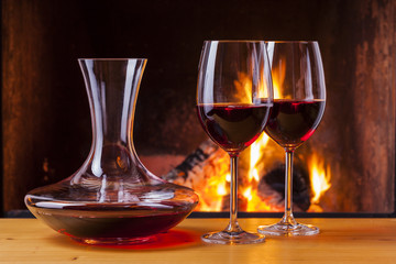 red wine at cozy fireplace