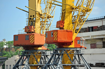 Port cargo crane over blue sky background