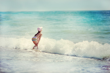 little girl playing in the waves