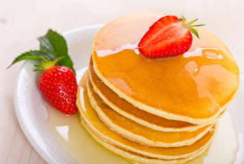 Pancakes with syrup and strawberry
