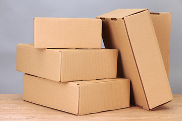 Parcels boxes on wooden table, on grey background