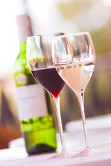 Glasses of wine with bottle in a restaurant setting