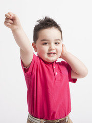 funny young boy playing in front of the camera