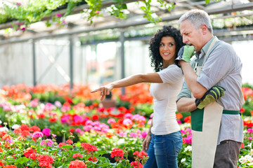 Fototapeta na wymiar Female customer choosing flowers in a greenhouse