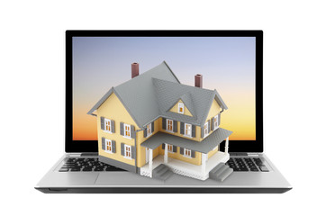 Yellow house on laptop isolated on white