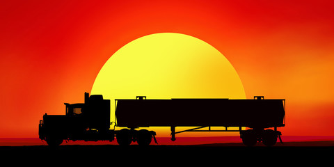 Silhouette of a truck in the background of the setting sun.