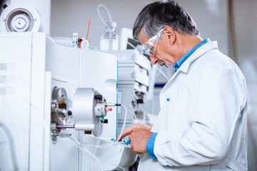 Senior male researcher carrying out scientific research in a lab