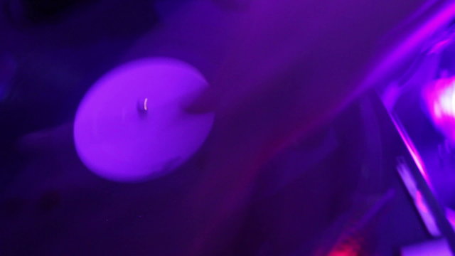 Dj scratching the vinyl record in night club, timelapse