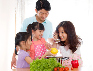 Asian woman tasting soup