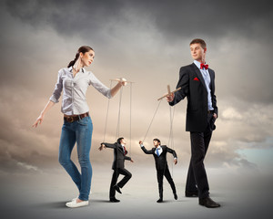 Businesspeople with marionettes