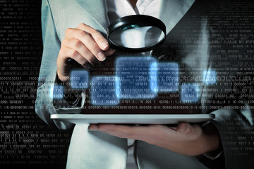 Businesswoman with magnifier glass