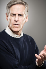 Mature Caucasian Man With Looking WIth Disapproval