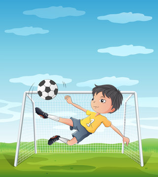 A young athlete kicking the soccer ball