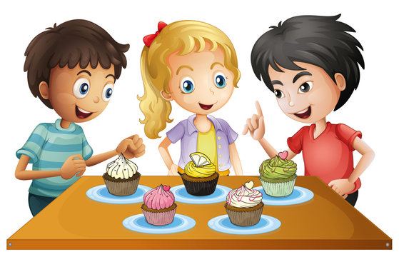 Three kids at the table with cupcakes