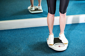 Cropped image of a woman measuring weight