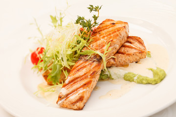 Grilled salmon steak with salad