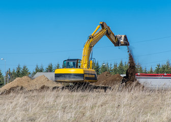 Excavator machine works at construction site