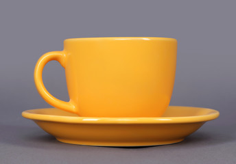 orange cup and saucer