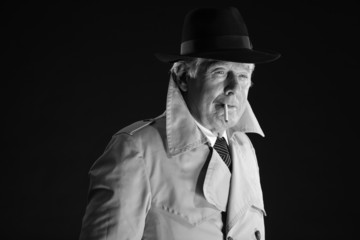 Retro mafia man with hat smoking cigarette. Black and white phot