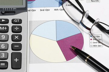 business financial chart analysis or empty circle graph with pen eyeglasses and calculator on paper work report for investment plan or market share analysis