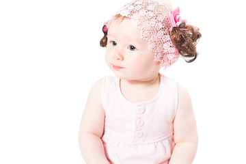 Little cute baby-girl with blue eyes in pink dress