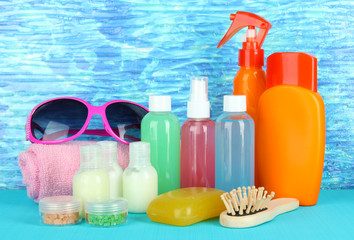Hotel cosmetics kit on bright color background