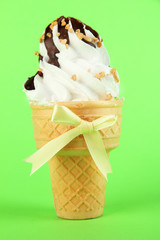 Tasty ice cream with chocolate, on green background