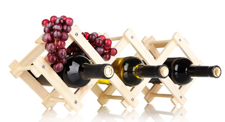 Bottles of wine placed on wooden stand isolated on white