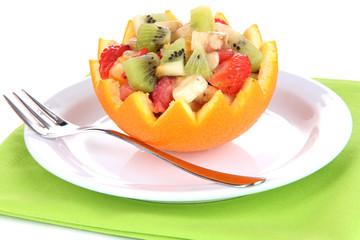 Fruit salad in hollowed-out orange isolated on white