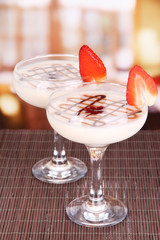 Fruit smoothies on table on window background