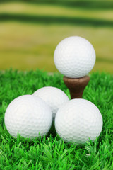 Golf balls on grass outdoor close up