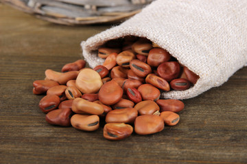 Beans in sack on wooden background